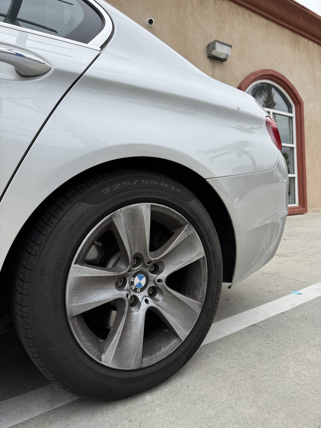 BMW wheel covered in brake dust and grime before wash at Fair Oaks Car Wash