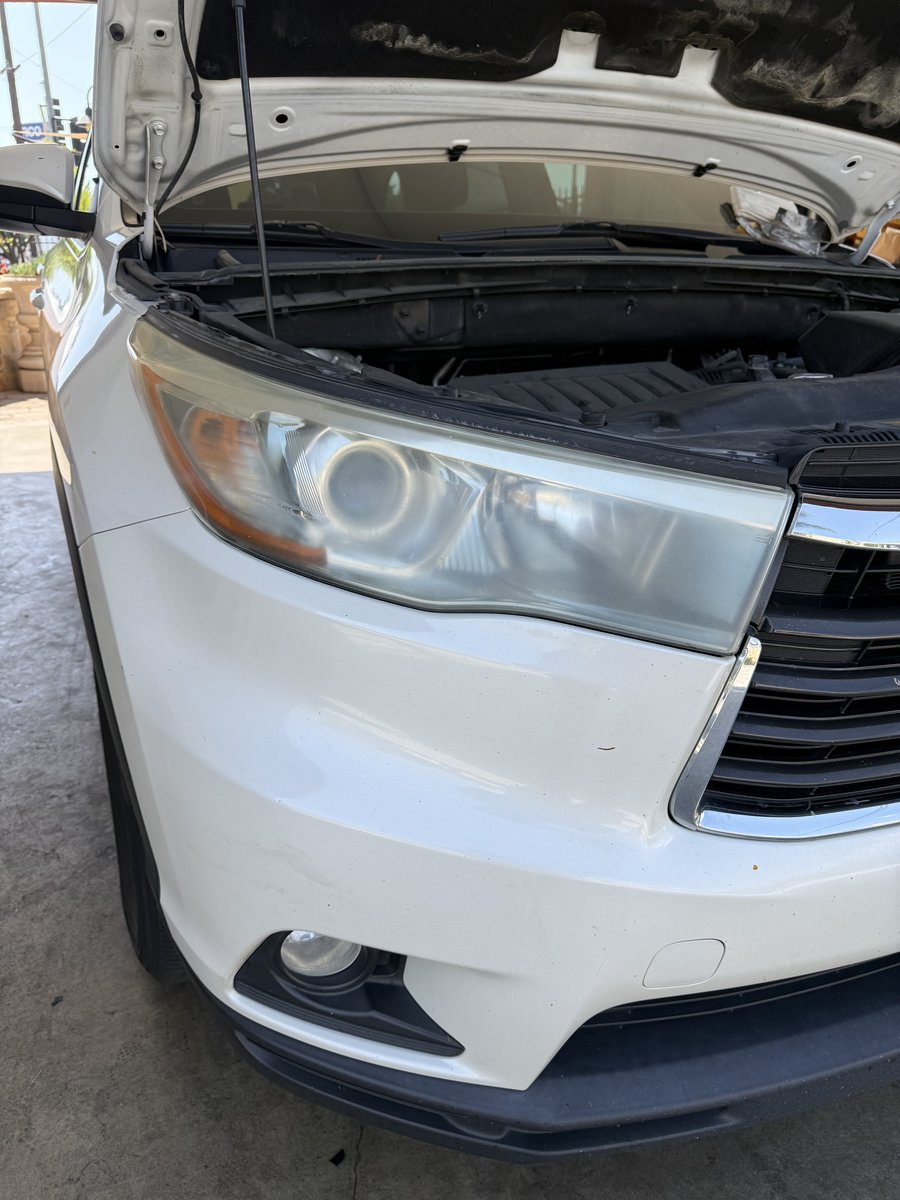 Toyota Highlander headlight with cloudy yellowed plastic before restoration at Fair Oaks Car Wash