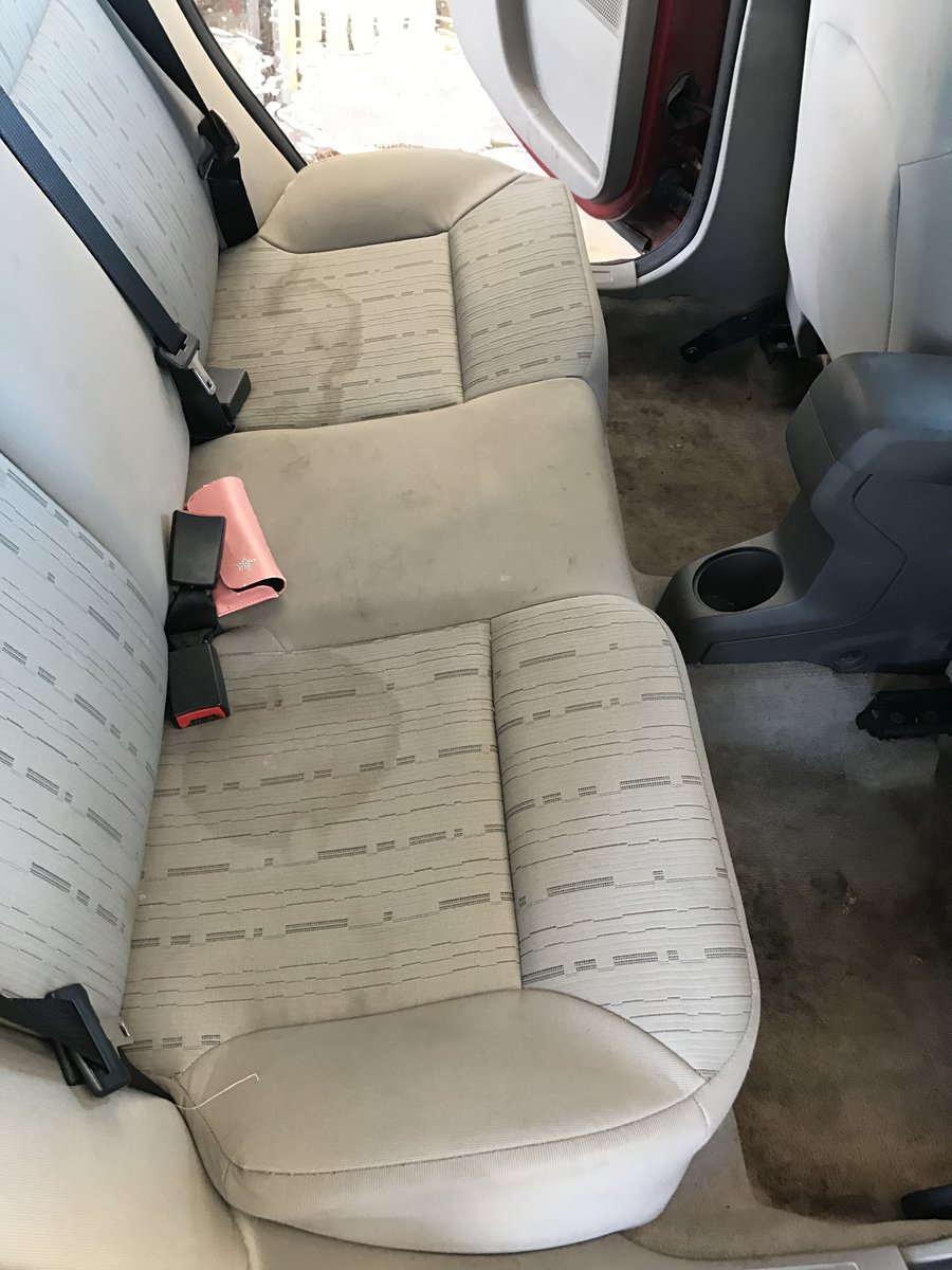 Stained dingy cloth seats before Interior Detail at Fair Oaks Car Wash