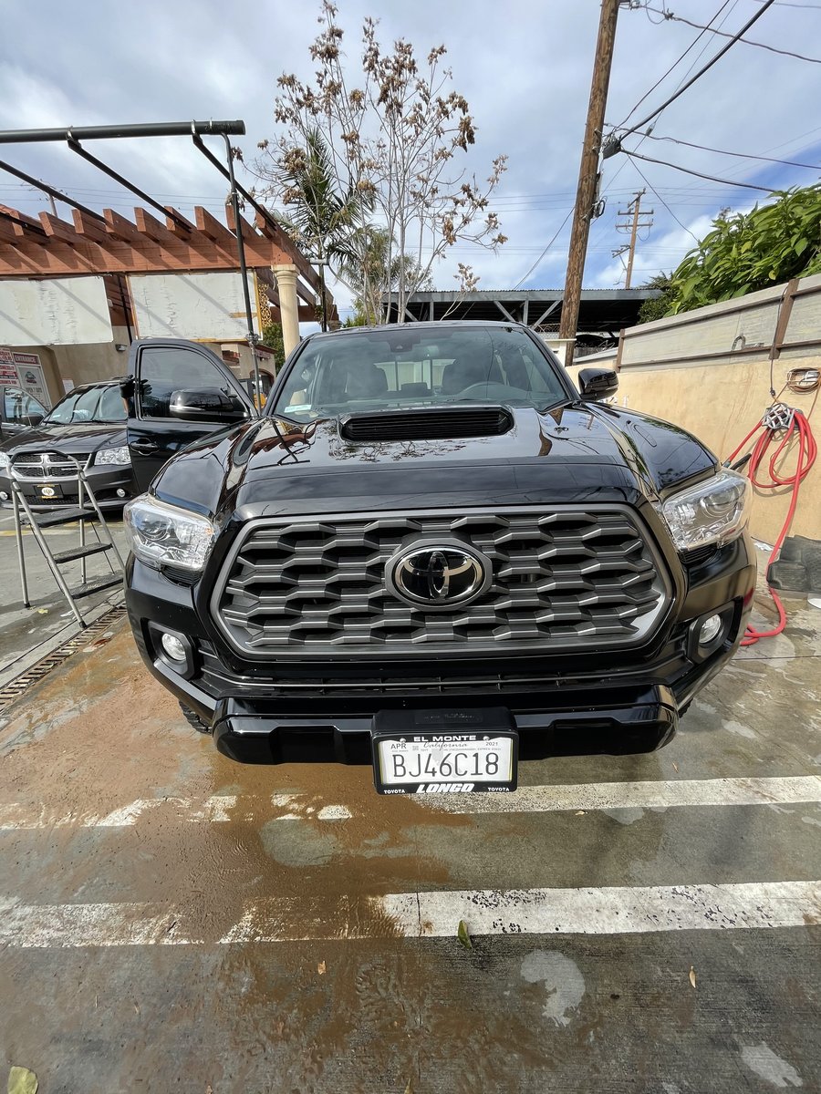 Same Toyota Tacoma after full detail showing glossy black factory finish at Fair Oaks Car Wash